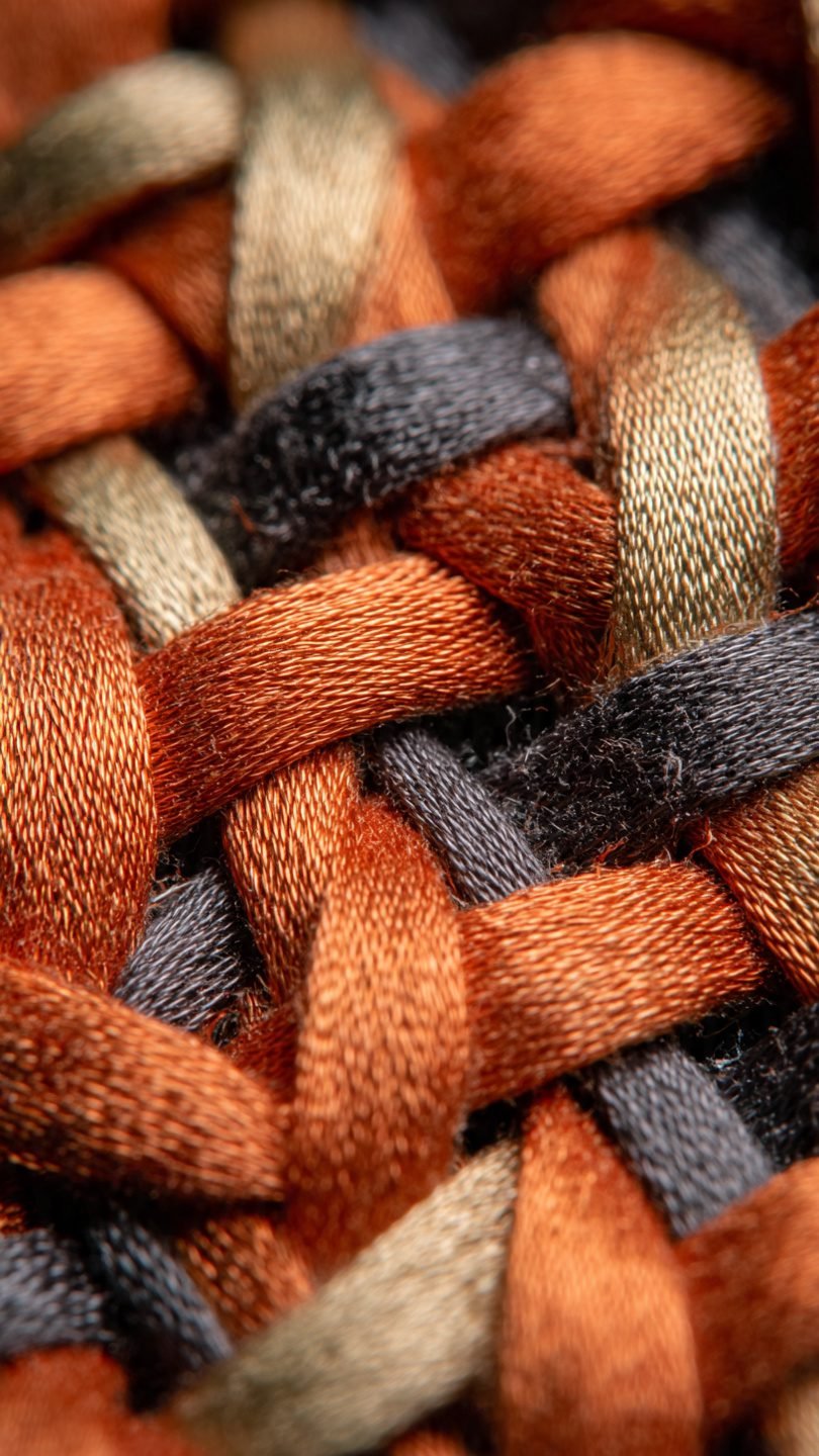 Mixed-material artistic wall tapestry with metallic elements