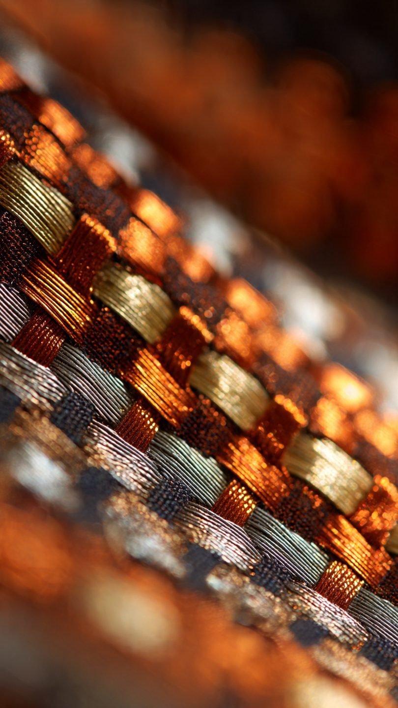 Mixed-material artistic wall tapestry with metallic elements